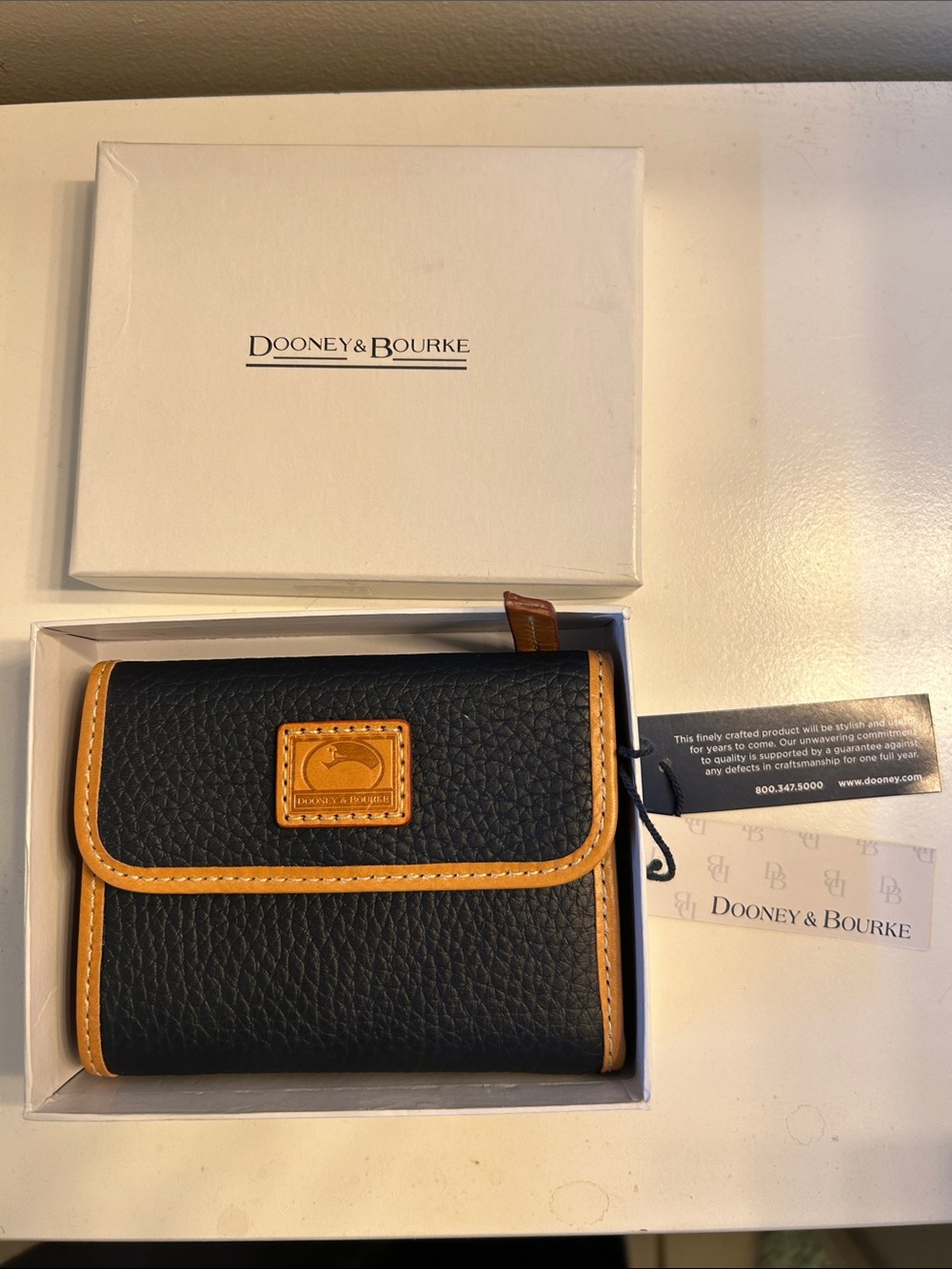 Dooney & Bourke Black Pebbled Leather Trifold Wallet with Tan Trim